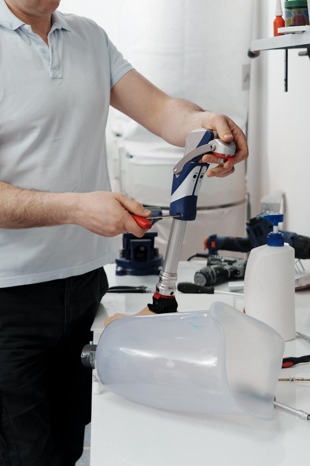 Craftsman adjusting a plumbing pipe with hand tools
